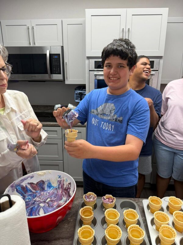 A Clubber practicing kitchen life skills by making ice cream cones