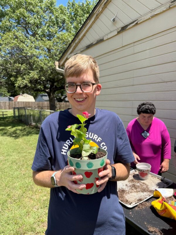 A clubber planting in the Clubhouse garden