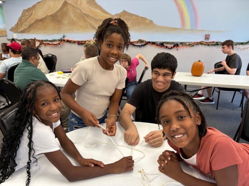 Clubbers building peer friendships during a group craft activity